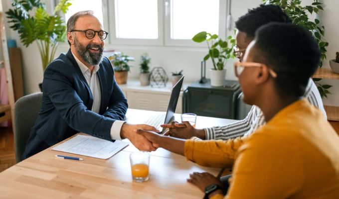 Young Black couple meeting with financial advisor to discuss finances