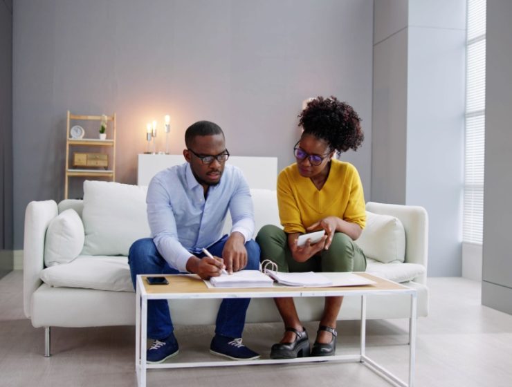 Young Black couple doing their expenses to file their tax report