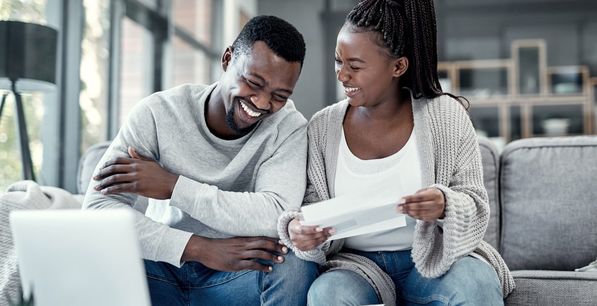 The perfect photo depicting marriage and money as a young Black married couple goves over bills